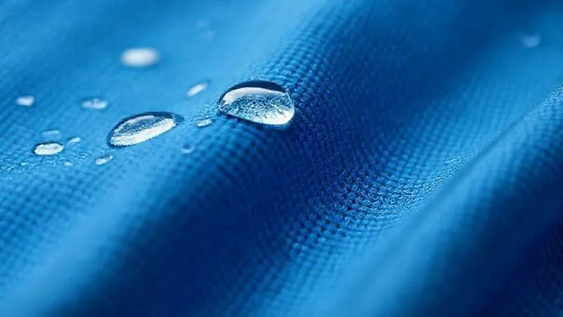 A close-up, photorealistic macro shot of a high-performance, seamless activewear fabric, showcasing its intricate weave and smooth texture. Water droplets bead perfectly on the surface, demonstrating its moisture-wicking properties. Cinematic lighting highlights the fabric's technical details. Professional photography, 8K, sharp focus, depth of field, shot on a high-end DSLR, emphasizing innovation and comfort.